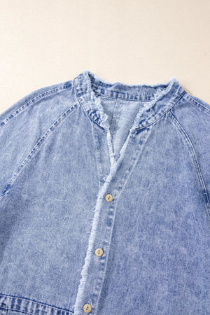 Acid wash denim shirtdress with raw hem, band collar, and button front in medium.