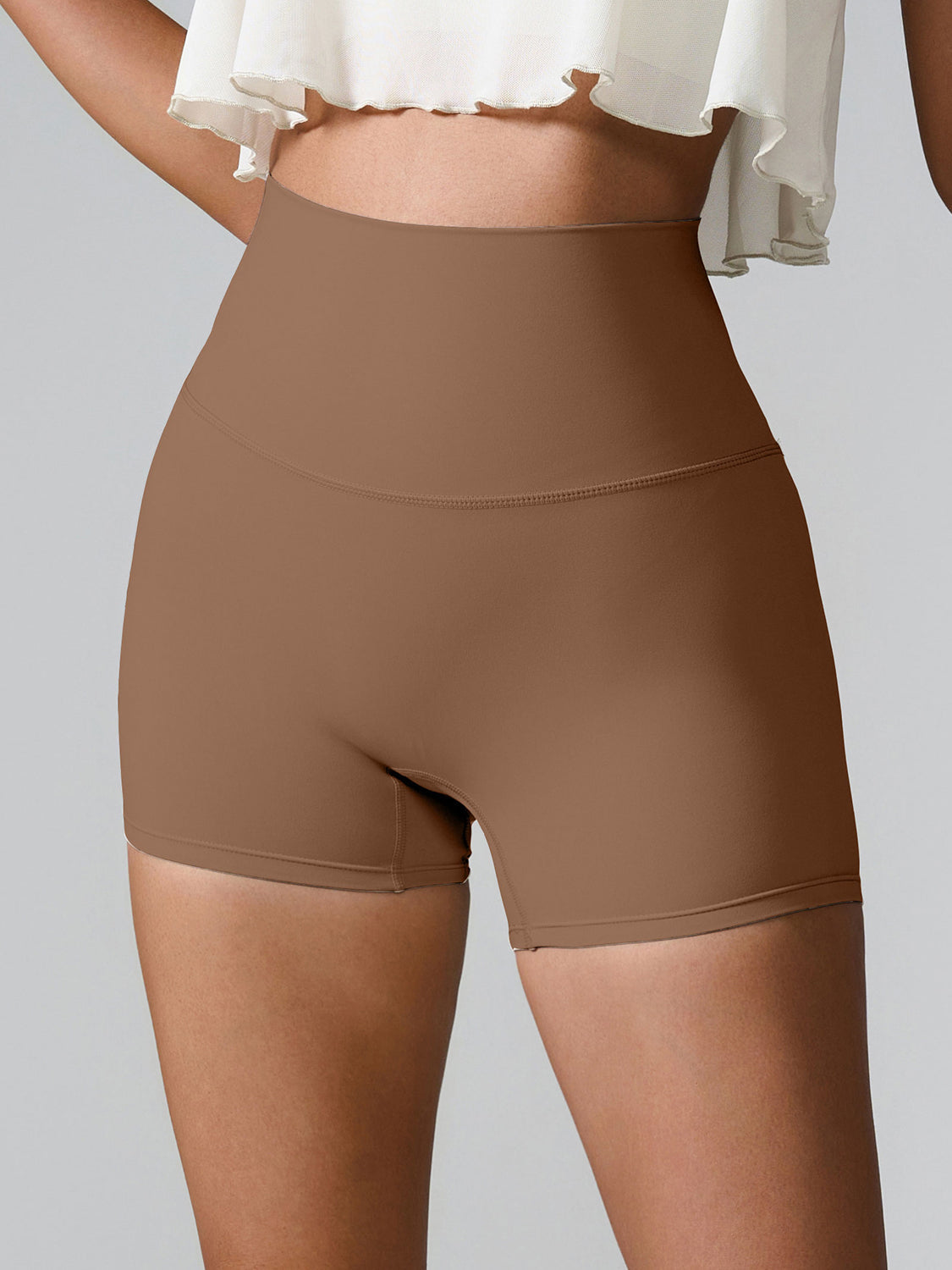 Sculpted high-waisted active shorts in Chestnut with a seamless design and subtle pocket detail.