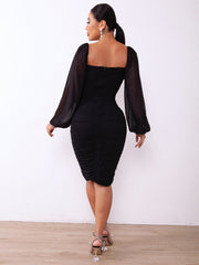 Black ruched bodycon dress with sheer bishop sleeves and square neckline.