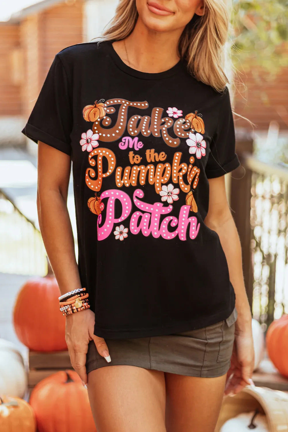 Black round neck tee with "Take Me to the Pumpkin Patch" graphic and floral accents.