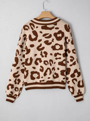 Chic leopard print knit sweater with a notched neckline and striped cuffs.
