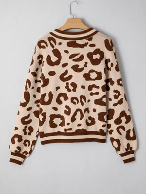 Chic leopard print knit sweater with a notched neckline and striped cuffs.