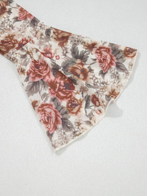 Charming floral mesh blouse with ruffled bell sleeves and a tie detail.