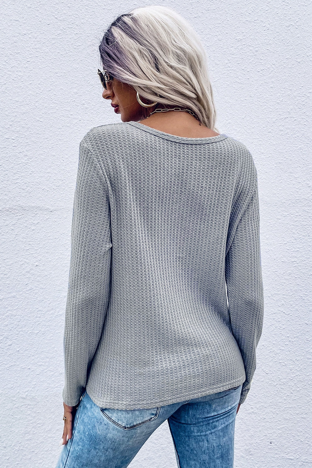 Gray waffle knit long sleeve top with knot detail, crew neck, casual fit.