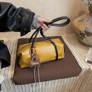 Yellow pu leather shoulder bag with charm and black handles