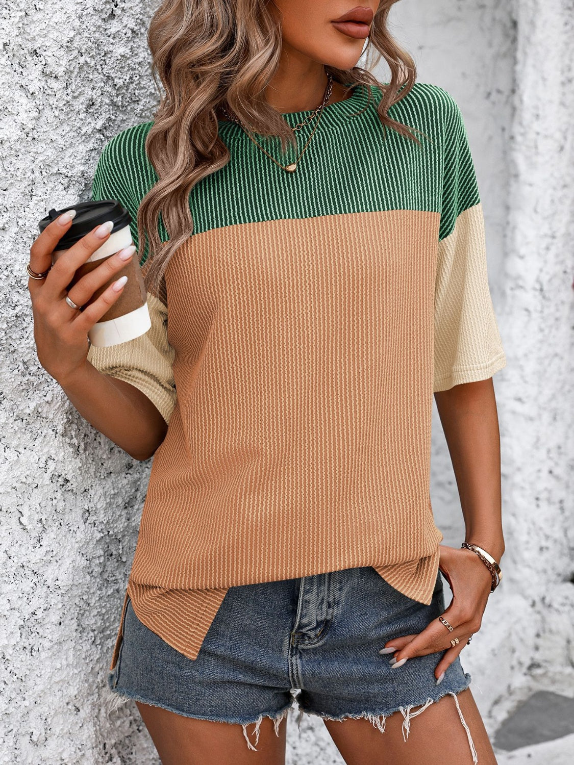 Colorblock t-shirt with green, camel, and cream panels, short sleeves, and a crew neck.