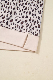 Leopard print cotton mini dress with zip-up collar and side slits.