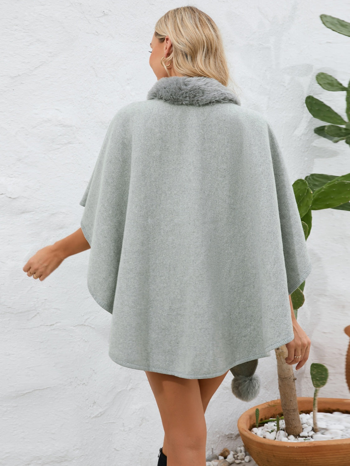 Gray faux fur collar wrap poncho with a pom-pom detail.