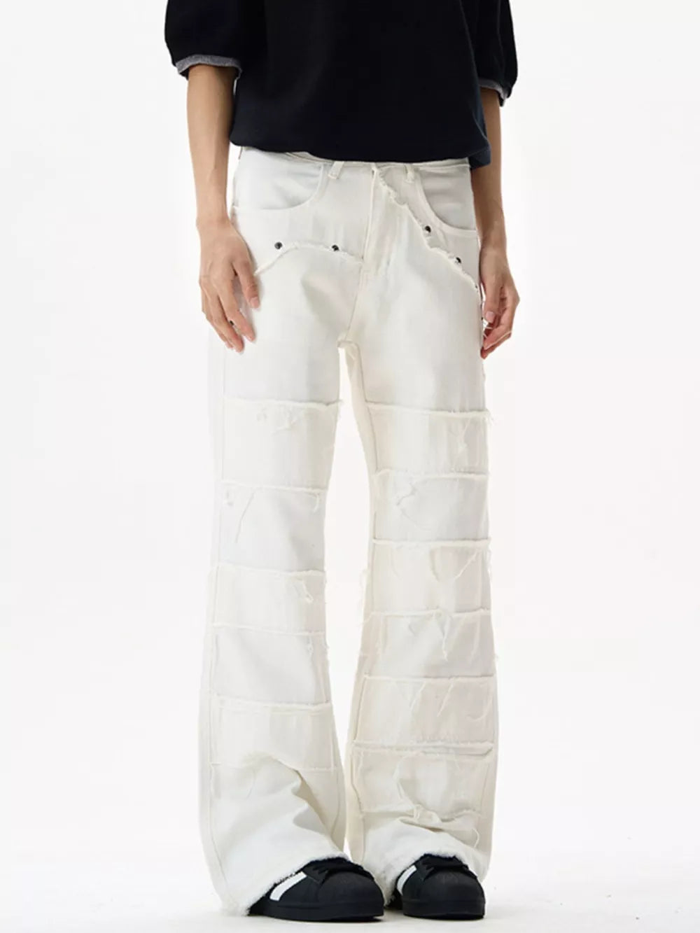 White stretch flare jeans with frayed hem detail and panel construction.