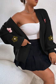 Black acrylic knit cardigan with embroidered flowers on sleeves and front