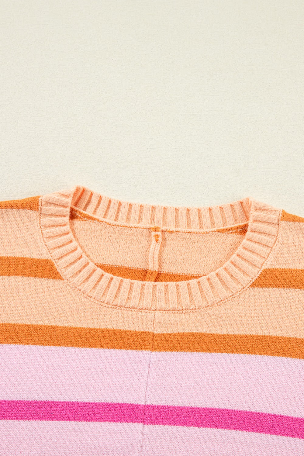 Ombre stripe knit sweater in sherbet with ribbed crew neck and horizontal stripes.