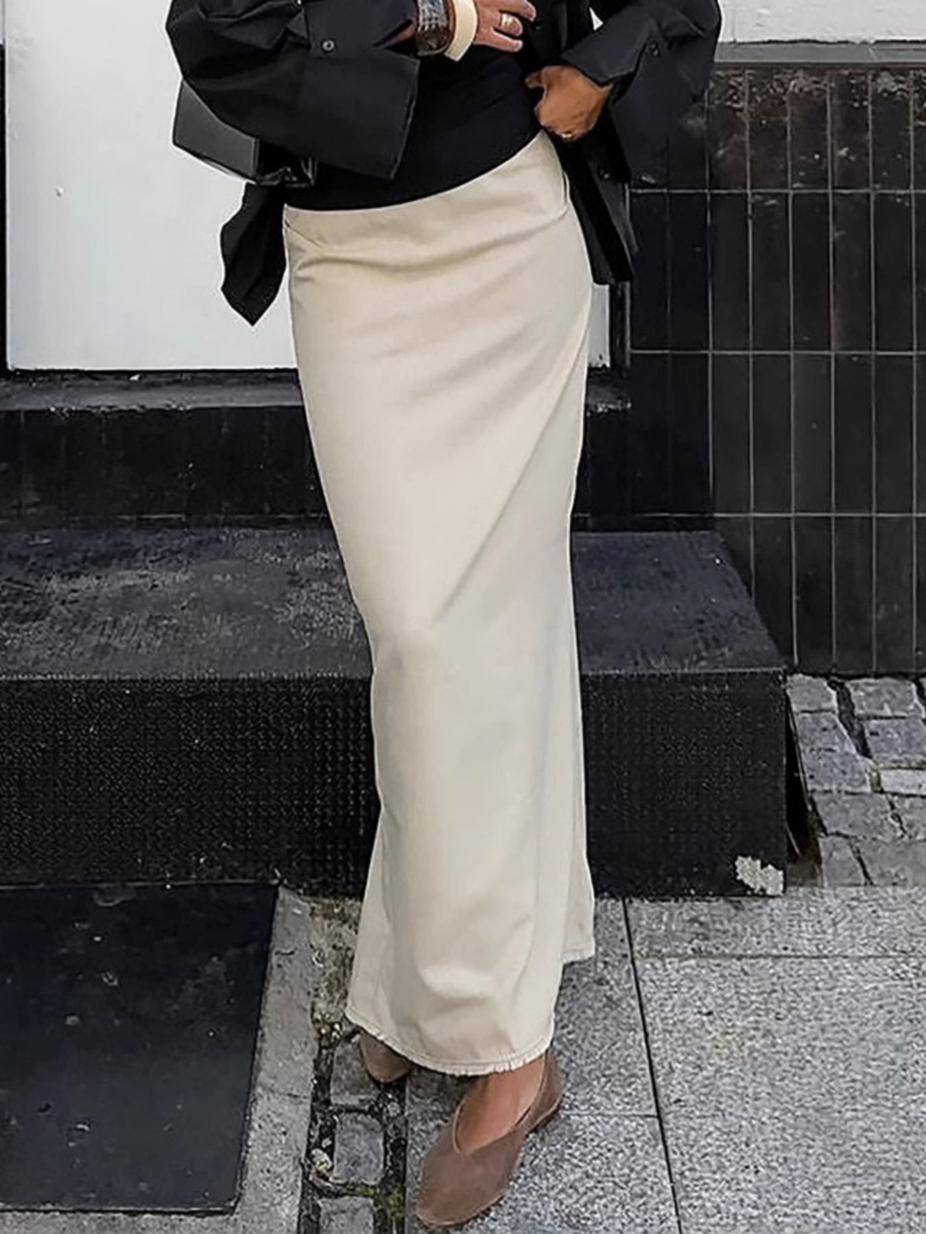 Chic beige cotton midi skirt with a slit, ankle length, styled with flats.