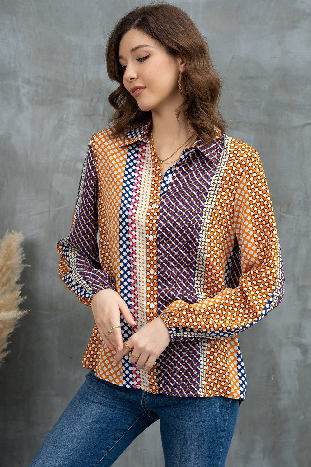 Geometric print blouson sleeve blouse with button front and collared neckline.