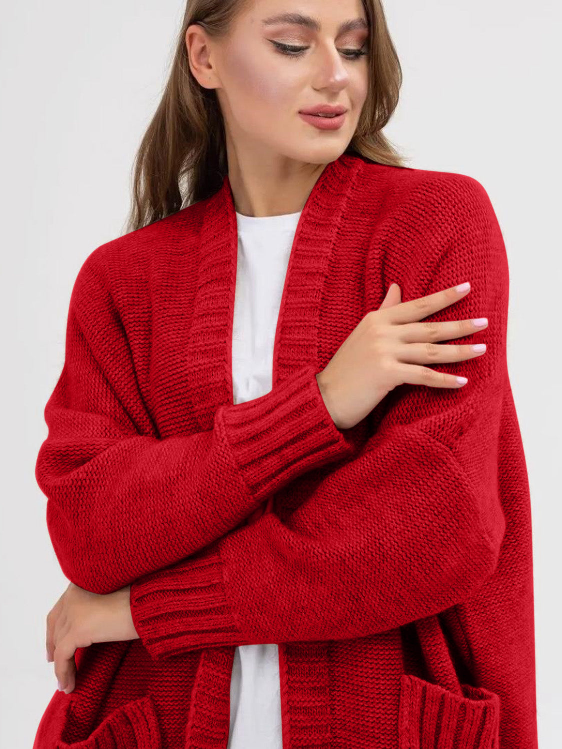 Scarlet oversized acrylic knit cocoon cardigan with pockets and ribbed cuffs.