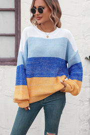 Ombre ribbed knit sweater with balloon sleeves in blue, white, and yellow stripes.