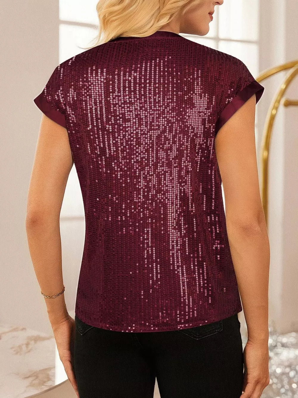 Burgundy sequin cap sleeve blouse with satin trim.