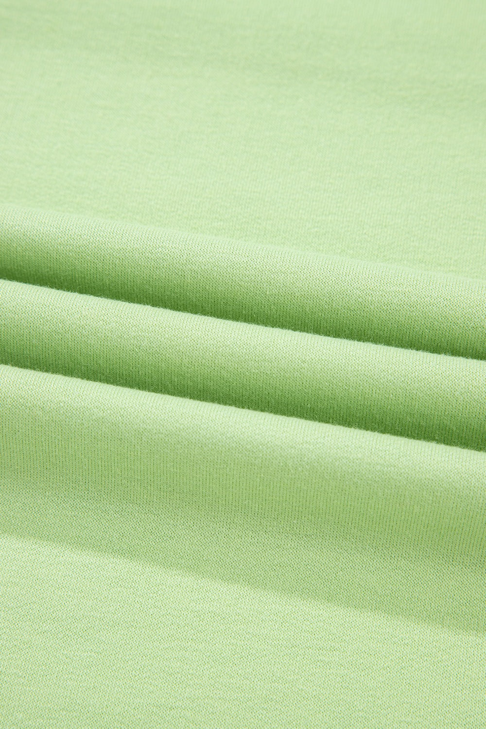 Lime cotton loungewear fabric detail showing soft texture and relaxed fit