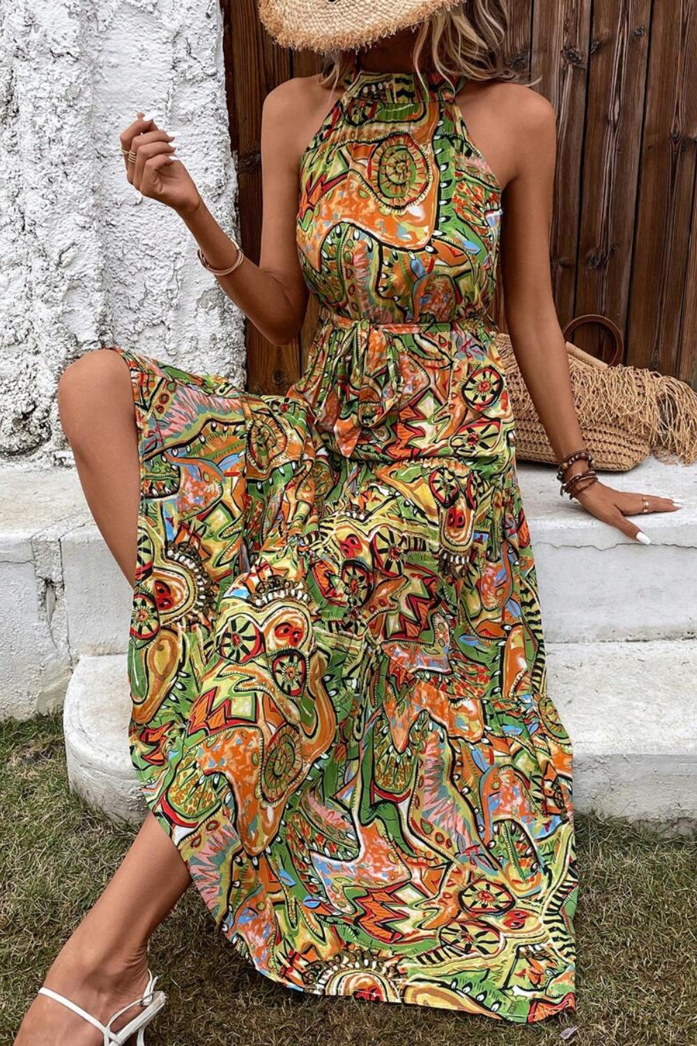 Halter neck maxi dress with a vibrant paisley print and tie waist detail.