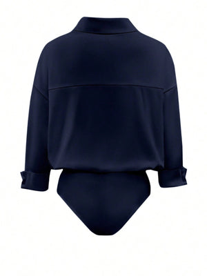 Navy blue long sleeve collared bodysuit with button detail on cuffs