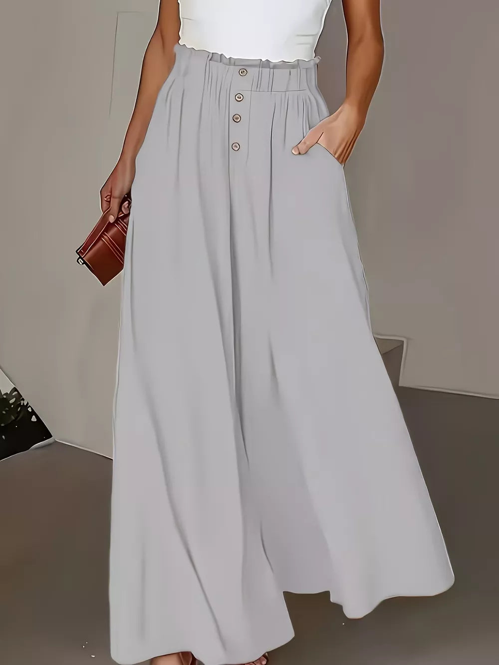 Light gray wide-leg pants with paperbag waist and button detail.