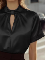 Black satin blouse with short sleeves, a twisted keyhole neckline, and a button-down front.