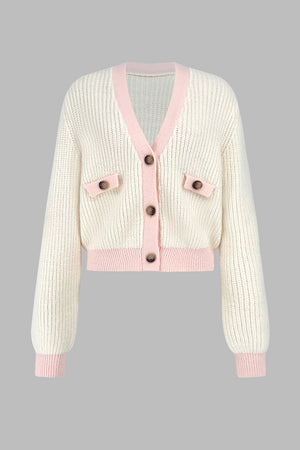 Cream cropped knit cardigan with pink trim and buttoned pockets