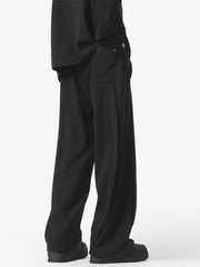 Men's black loose fit drawstring pants with side pocket detail.