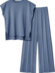 Seamed knit wide-leg co-ord set in dusty blue, featuring a cap-sleeve top with side slits and pleated pants.
