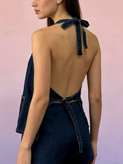 Button-down denim halter vest in dark blue with a tie back and pocket detail.