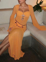 Orange knit maxi dress with bell sleeves and a keyhole cutout detail.