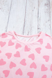 Blush pink pajama top with allover heart print and crew neck.