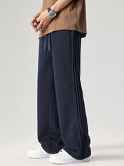 Men's navy relaxed fit sweatpants with drawstring and side seam detail.