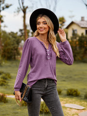 Dusty purple ruffled henley blouse with button detail and long sleeves.
