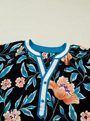 Black floral print blouse with bubble sleeves and button-down detail.