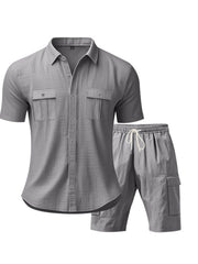 Grey relaxed-fit button-up shirt with two chest pockets and drawstring shorts.