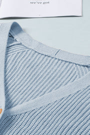 Light blue diamond-cut sleeve knit cardigan with ribbed texture and button detail.