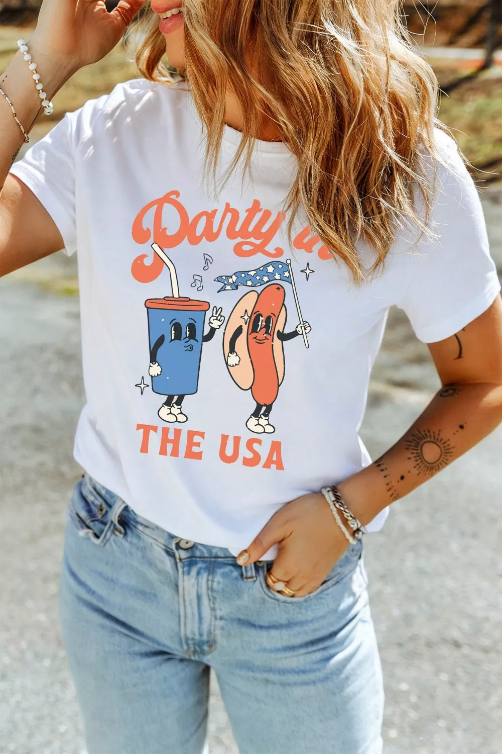 White polyester t-shirt with retro patriotic graphic of a hot dog and drink, "Party in the USA" text.