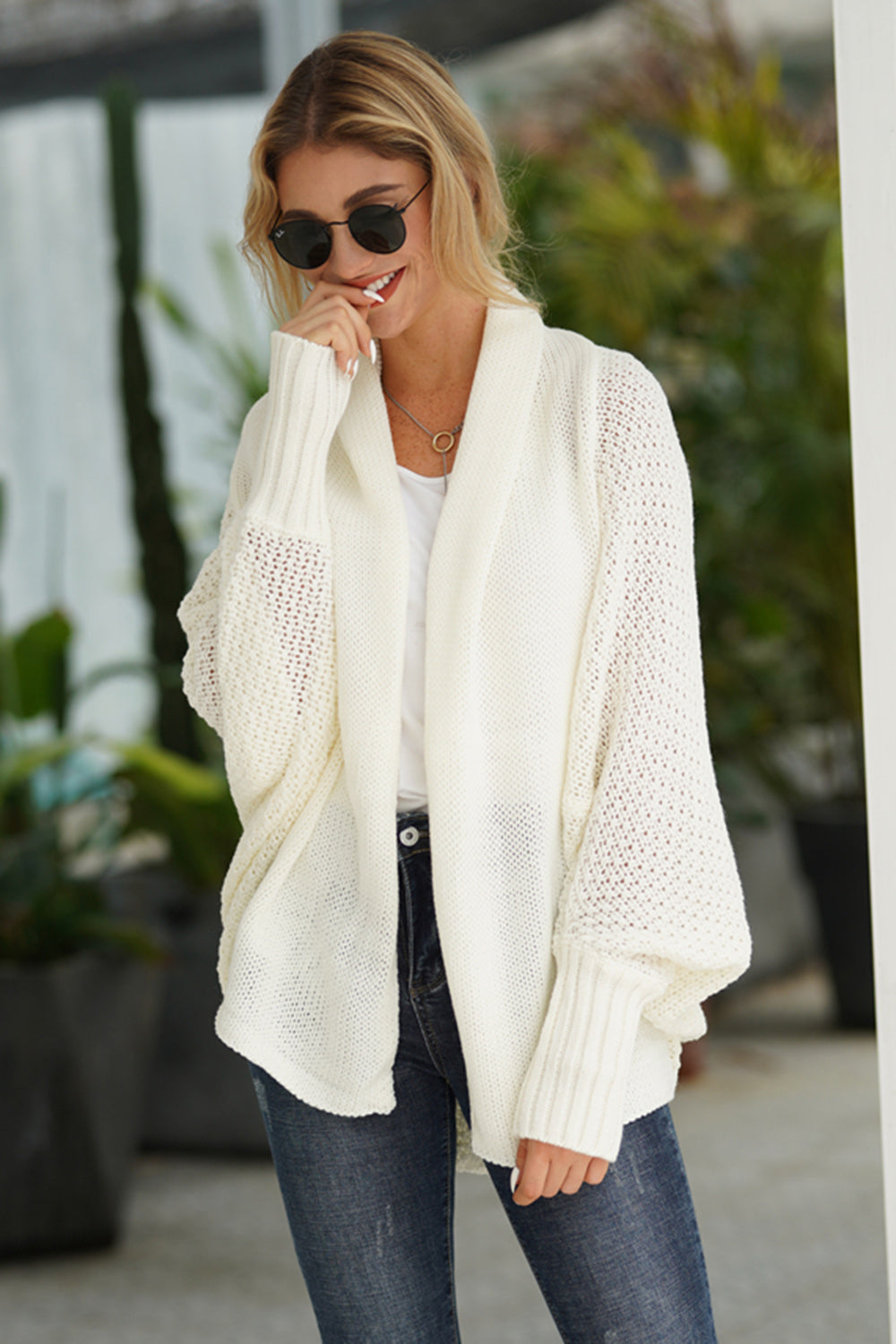 White acrylic knit cardigan with open front and balloon sleeves