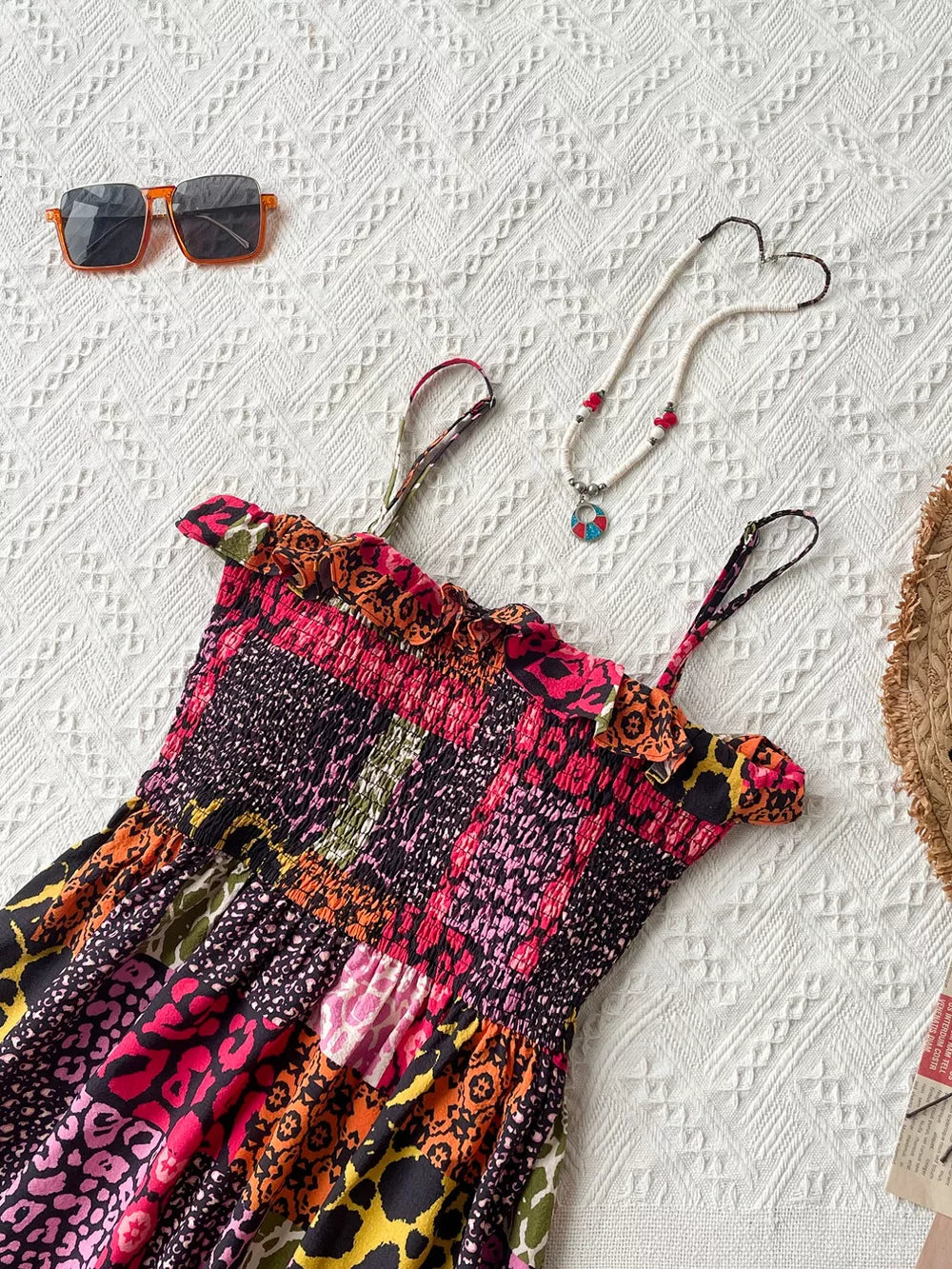 Frilled smocked maxi dress with abstract animal print, spaghetti straps, and colorful patchwork design.