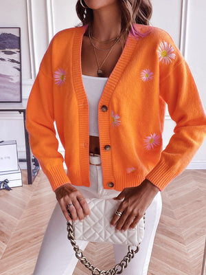 Tangerine button-down cardigan with embroidered daisies and ribbed cuffs.