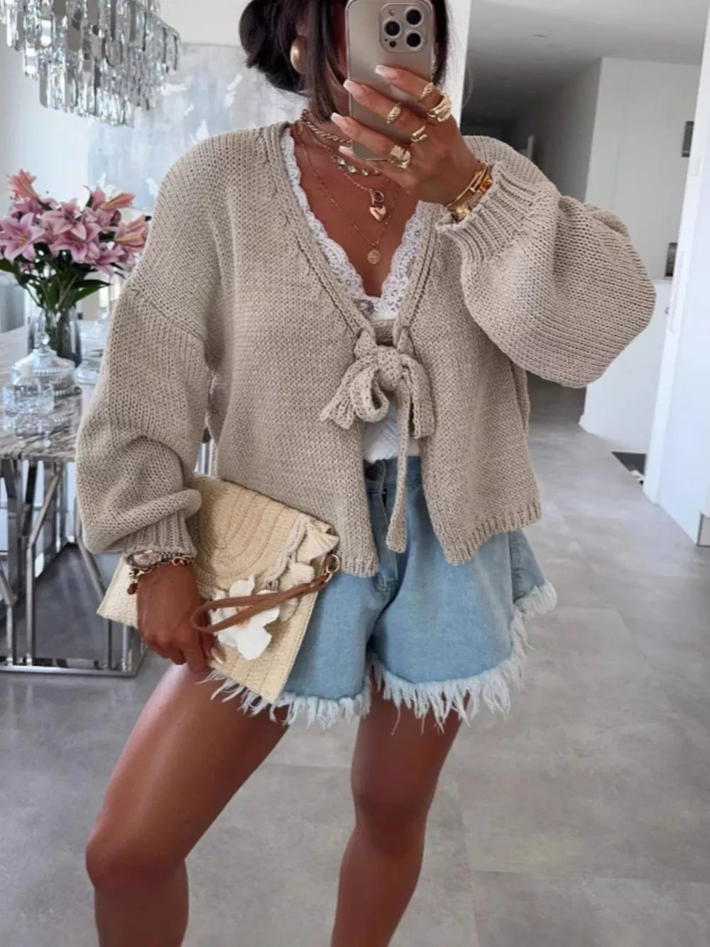 Textured tie-front knit cardigan in cream with lace trim and balloon sleeves.