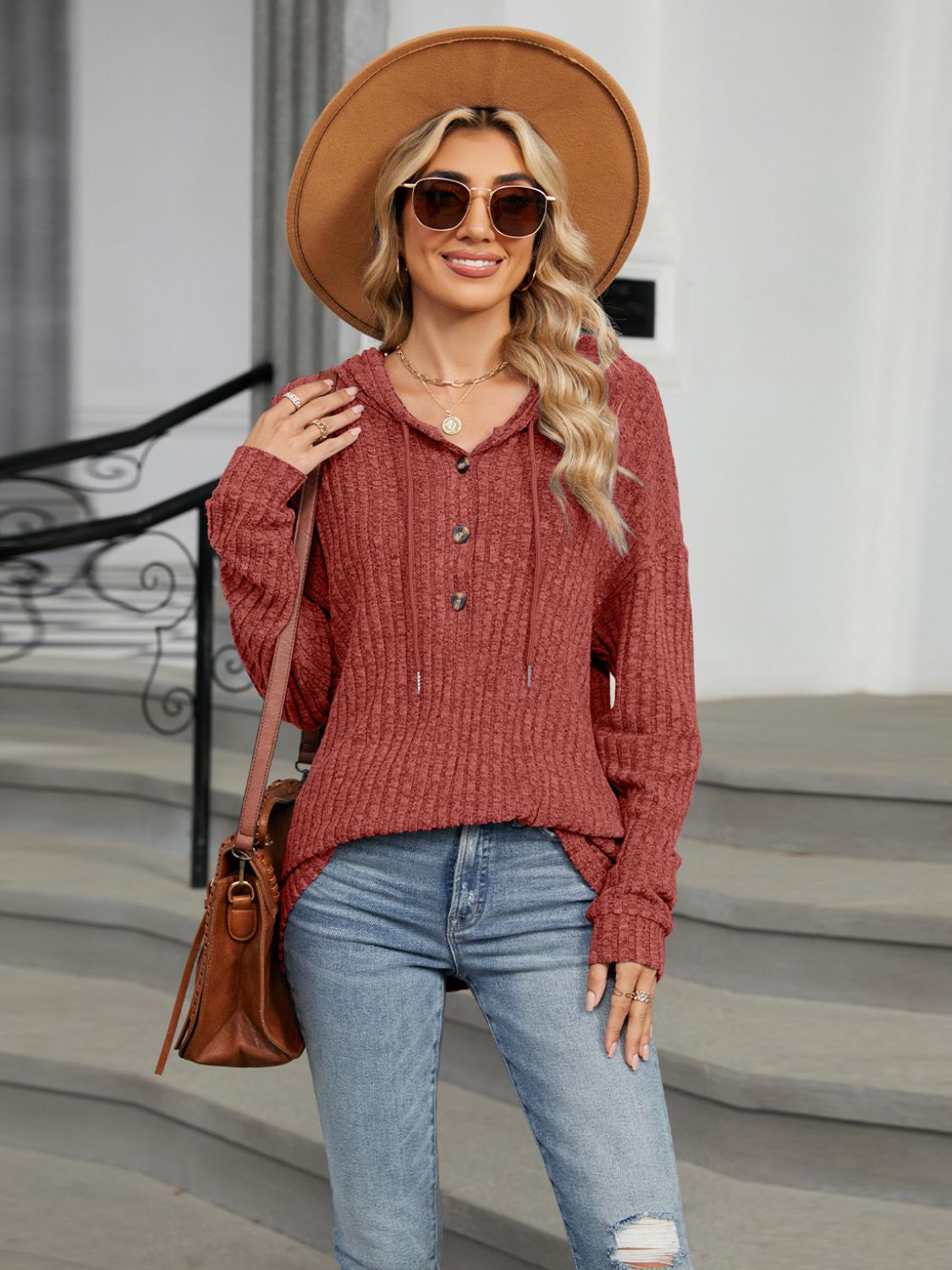 Ribbed knit henley hoodie in rust with button detail and drawstring hood.