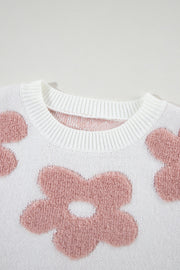 White knit pullover with textured pink floral pattern and crew neck.