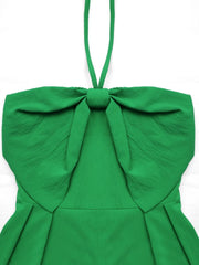 Green halterneck romper with large bow detail and smocked back.