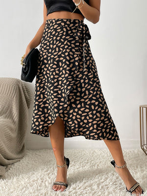 Asymmetric wrap skirt in black with abstract tan print, midi length, tie waist