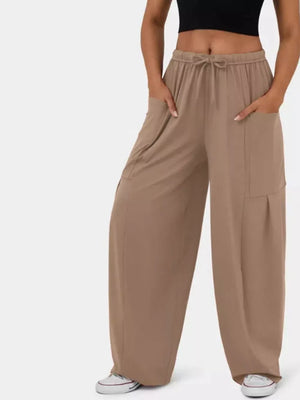 Tan wide-leg jeggings with drawstring waist and cargo pockets.