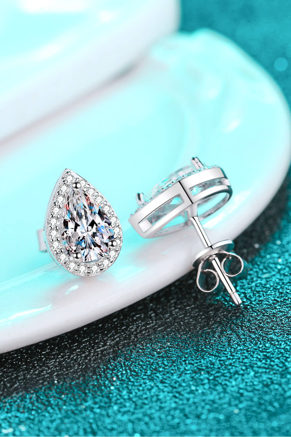 Silver teardrop halo stud earrings with clear pavé crystals.