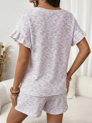 Ruffled sleeve two-piece set in white with purple flecks, featuring textured fabric and drawstring shorts.