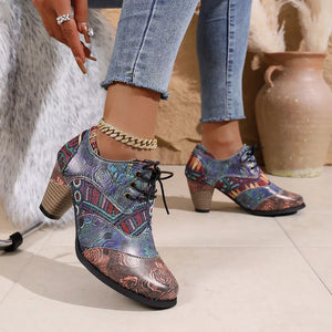 Floral patchwork lace-up ankle boots with a block heel and embossed rose detail.
