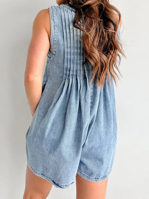 Light blue denim playsuit with pleated back detail and A-line shorts.